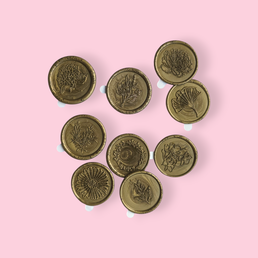 A photo of the Botanical collection spread against a light pink background. The seals depict: a hydrangea, a fresh bouquet, a ginko leaf, rosemary twigs, a wreath, a peony, a daisy, a branch, and a flower stem.