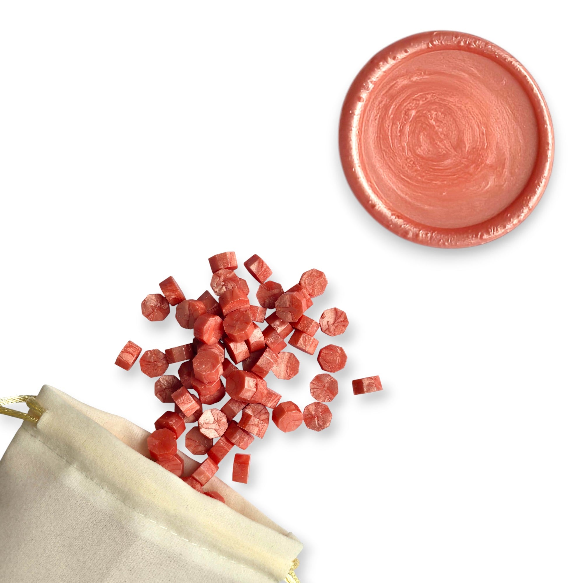 Coral wax beads spilling out of a beige drawstring bag onto a white background. In the top right corner is a blank wax seal in the showcasing the coral colour option.