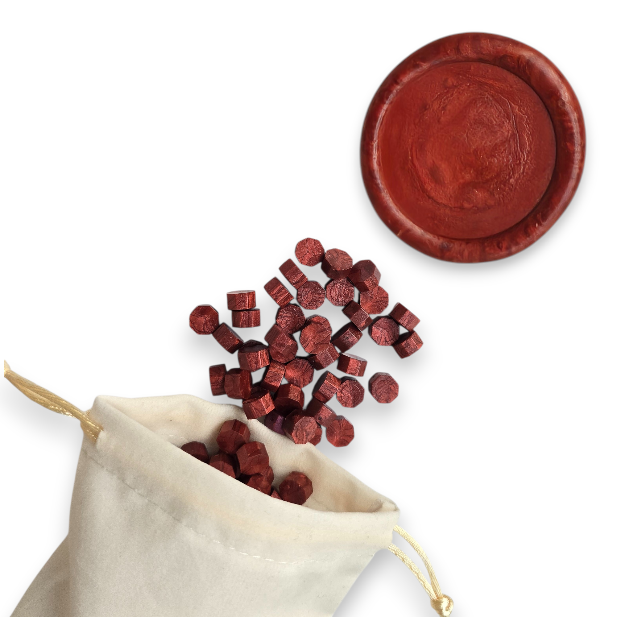 Ruby wax beads spilling out of a beige drawstring bag onto a white background. In the top right corner is a blank wax seal in the showcasing the ruby colour option.