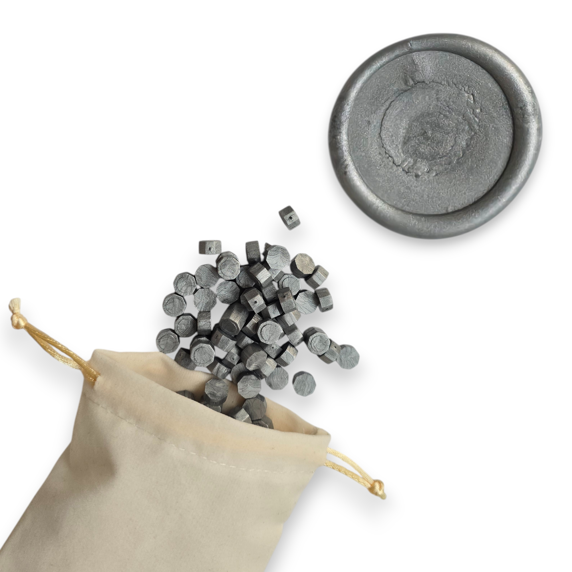 Silver wax beads spilling out of a beige drawstring bag onto a white background. In the top right corner is a blank wax seal in the showcasing the silver colour option.